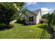 Well-kept yard with green grass, landscaping, and air conditioning unit at 5806 Autumn Trace Ln, Indian Trail, NC 28079