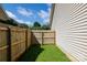 The side yard features a wooden fence and lush green grass at 5806 Autumn Trace Ln, Indian Trail, NC 28079