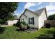 Landscaped yard with grass and flower beds adjacent to siding and fence at 5806 Autumn Trace Ln, Indian Trail, NC 28079