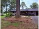 Secluded backyard featuring a brick home and mature trees at 605 Impala Dr, Albemarle, NC 28001
