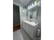 The well-lit bathroom features marble floors, a large mirror, and updated vanity cabinets, and creates a clean, spa-like feel at 605 Impala Dr, Albemarle, NC 28001