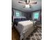 Comfortable bedroom featuring a ceiling fan, windows, and patterned rug at 605 Impala Dr, Albemarle, NC 28001