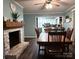 The dining area features a fireplace, dark hardwood floors, and flows into the kitchen, perfect for gathering and entertaining at 605 Impala Dr, Albemarle, NC 28001