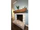 A stylish fireplace with a stone facade and a wooden mantel creates a cozy focal point in the living space at 605 Impala Dr, Albemarle, NC 28001