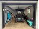 Clean garage featuring a golf cart, windows and gray walls at 605 Impala Dr, Albemarle, NC 28001