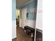 Hallway featuring a shoe storage bench and decor, adjacent to the laundry room at 605 Impala Dr, Albemarle, NC 28001