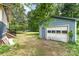View of the backyard with a detached garage and grassy area at 6206 Hunter Ave, Charlotte, NC 28262