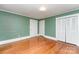 Bright bedroom features hardwood floors, neutral walls, and ample closet space at 6206 Hunter Ave, Charlotte, NC 28262