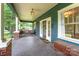 Inviting covered front porch with seating area and charming details, offering a relaxing outdoor space at 6206 Hunter Ave, Charlotte, NC 28262