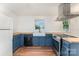 Modern kitchen with stainless steel appliances, butcher block countertops and blue cabinets at 6206 Hunter Ave, Charlotte, NC 28262