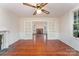 Living room with hardwood floors, fireplace, and access to a connected space through glass doors at 6206 Hunter Ave, Charlotte, NC 28262