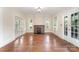 Spacious living room featuring hardwood floors, a brick fireplace, and ample natural light at 6206 Hunter Ave, Charlotte, NC 28262