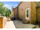 Brick home's backyard featuring a stone patio with a grill and seating area at 6565 Robin Hollow Dr, Mint Hill, NC 28227