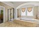 Relaxing bathroom with large soaking tub, separate shower, and tiled surround at 6565 Robin Hollow Dr, Mint Hill, NC 28227