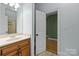 Bathroom with granite countertop and wood cabinets offers plenty of storage and style at 6565 Robin Hollow Dr, Mint Hill, NC 28227