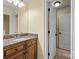 Bathroom with wood cabinets, granite countertop, and a mirror for morning preparations at 6565 Robin Hollow Dr, Mint Hill, NC 28227