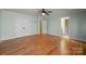 Spacious bedroom with light green walls, hardwood floors, and a ceiling fan at 6565 Robin Hollow Dr, Mint Hill, NC 28227