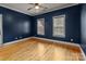 The bedroom offers pristine hardwood floors and walls painted a beautiful shade of blue at 6565 Robin Hollow Dr, Mint Hill, NC 28227