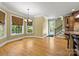 Bright dining room with hardwood floors, chandelier, and large windows overlooking the yard at 6565 Robin Hollow Dr, Mint Hill, NC 28227