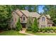 Stunning stone and brick home featuring mature landscaping and a meticulously maintained lawn at 6565 Robin Hollow Dr, Mint Hill, NC 28227