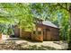 Beautiful brick home exterior surrounded by lush greenery and mature trees at 6565 Robin Hollow Dr, Mint Hill, NC 28227