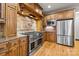 Close-up view of a professional-grade range and stainless refrigerator in a well-appointed kitchen at 6565 Robin Hollow Dr, Mint Hill, NC 28227