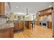 Open kitchen with custom wood cabinetry, granite countertops, stainless appliances, and a large center island at 6565 Robin Hollow Dr, Mint Hill, NC 28227