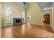 Spacious living room with hardwood floors, stone fireplace, and multiple archways to other rooms at 6565 Robin Hollow Dr, Mint Hill, NC 28227