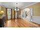 Formal living room featuring hardwood floors, large windows, and an arched doorway at 6565 Robin Hollow Dr, Mint Hill, NC 28227
