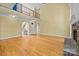 Open-concept living room with fireplace, hardwood floors, and view of the staircase at 6565 Robin Hollow Dr, Mint Hill, NC 28227