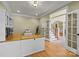 Bright office with hardwood floors, built-in cabinets, and an open doorway to the main foyer at 6565 Robin Hollow Dr, Mint Hill, NC 28227