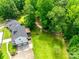 Aerial view of a white two-story home with attached garage, luscious backyard, and wooded surroundings at 675 Ormand Rd, York, SC 29745