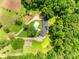 An aerial view features a home with an inground pool, surrounded by lush greenery and a long driveway at 675 Ormand Rd, York, SC 29745
