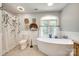 Bright bathroom with standalone tub, natural light, and decorative accents and tiled flooring at 675 Ormand Rd, York, SC 29745