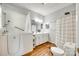 Bright bathroom featuring a walk-in tub, double vanity, and stylish wood-look flooring at 675 Ormand Rd, York, SC 29745