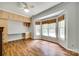 Bedroom featuring a large bay window, wood floors, built-in desk, and overhead cabinets at 675 Ormand Rd, York, SC 29745