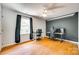 Bright bedroom with dark accent wall, hardwood floors, and a ceiling fan at 675 Ormand Rd, York, SC 29745