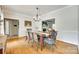 Dining room features a chandelier and hardwood floors and views to the living room with fireplace at 675 Ormand Rd, York, SC 29745