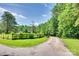 A long, winding gravel driveway leads to this beautiful estate with a wooden fence at 675 Ormand Rd, York, SC 29745