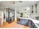 Open kitchen featuring modern gray cabinets, stainless steel appliances, large island and tiled floor at 675 Ormand Rd, York, SC 29745