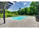 Backyard view of an inground pool surrounded by black metal fencing and lush greenery at 675 Ormand Rd, York, SC 29745