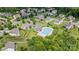 Aerial view of community pool, playground, and common areas surrounded by well-maintained homes and lush landscaping at 7129 Dove Field Ln, Fort Mill, SC 29707