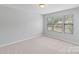 Bright bedroom features neutral walls, plush carpet, and multiple windows at 7129 Dove Field Ln, Fort Mill, SC 29707
