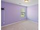 Cozy bedroom with lilac walls, carpet, and a window offering natural light at 7129 Dove Field Ln, Fort Mill, SC 29707