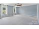 Spacious bedroom with ample natural light, ceiling fan, and neutral decor at 7129 Dove Field Ln, Fort Mill, SC 29707