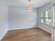 Empty bedroom featuring hardwood floors, a window and neutral paint at 7129 Dove Field Ln, Fort Mill, SC 29707