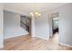 Dining area featuring hardwood floors, chandelier, staircase and kitchen access at 7129 Dove Field Ln, Fort Mill, SC 29707