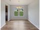 Dining area with hardwood floors, chandelier, and a view of the outdoors at 7129 Dove Field Ln, Fort Mill, SC 29707