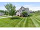 A well-maintained two-story home boasts a lush lawn and convenient two-car garage at 7129 Dove Field Ln, Fort Mill, SC 29707