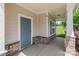 Inviting front porch with stone accents and a stylish blue front door at 7129 Dove Field Ln, Fort Mill, SC 29707
